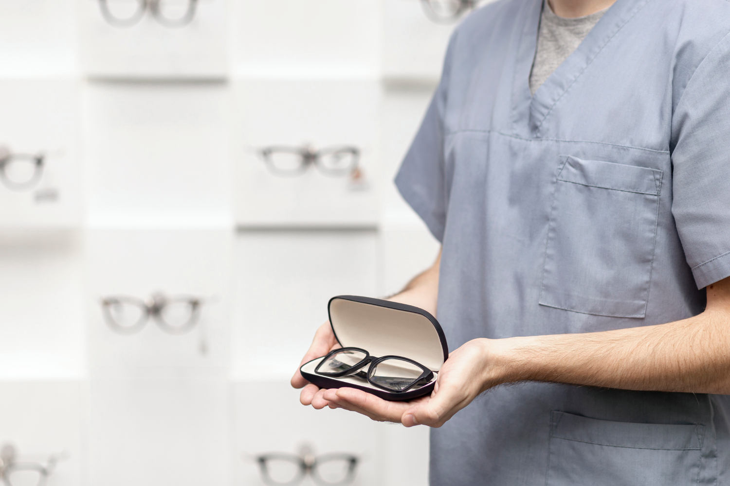 aaside view view man holding pair glasses case