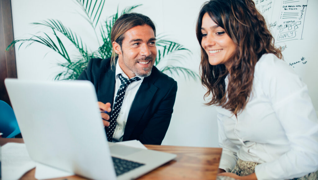 smiling businessman working with her fellow (1)